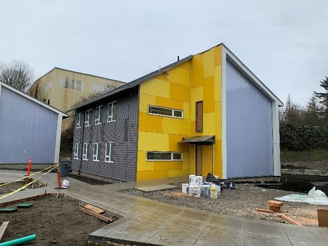 A yellow and purple building with a lot of windows