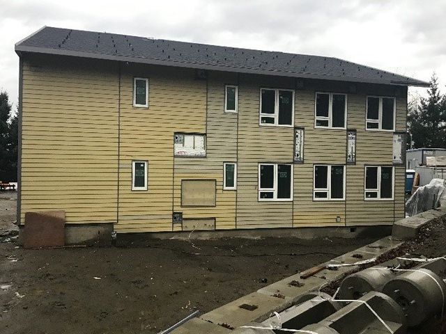 A large building with a lot of windows is being built