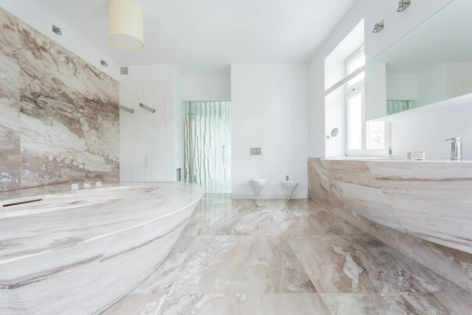 A bathroom with a tub , sink and mirror.