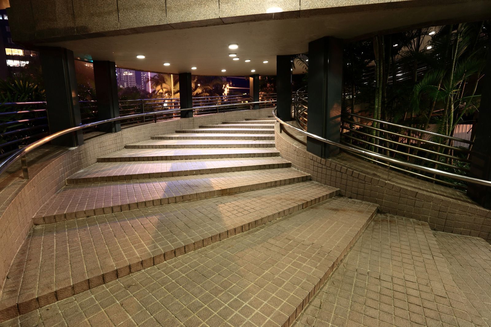 A set of stairs leading up to a building at night.