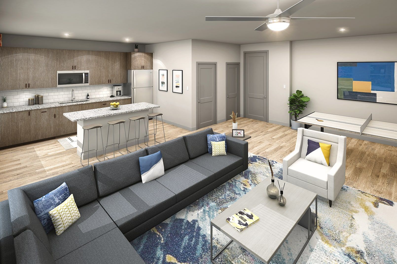 Open-concept living space with a modern kitchen island, bar stools, and seating.