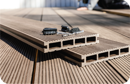 Two pieces of wood are sitting on top of each other on a wooden deck.