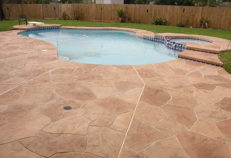 Pool with a textured, flagstone-patterned concrete patio.