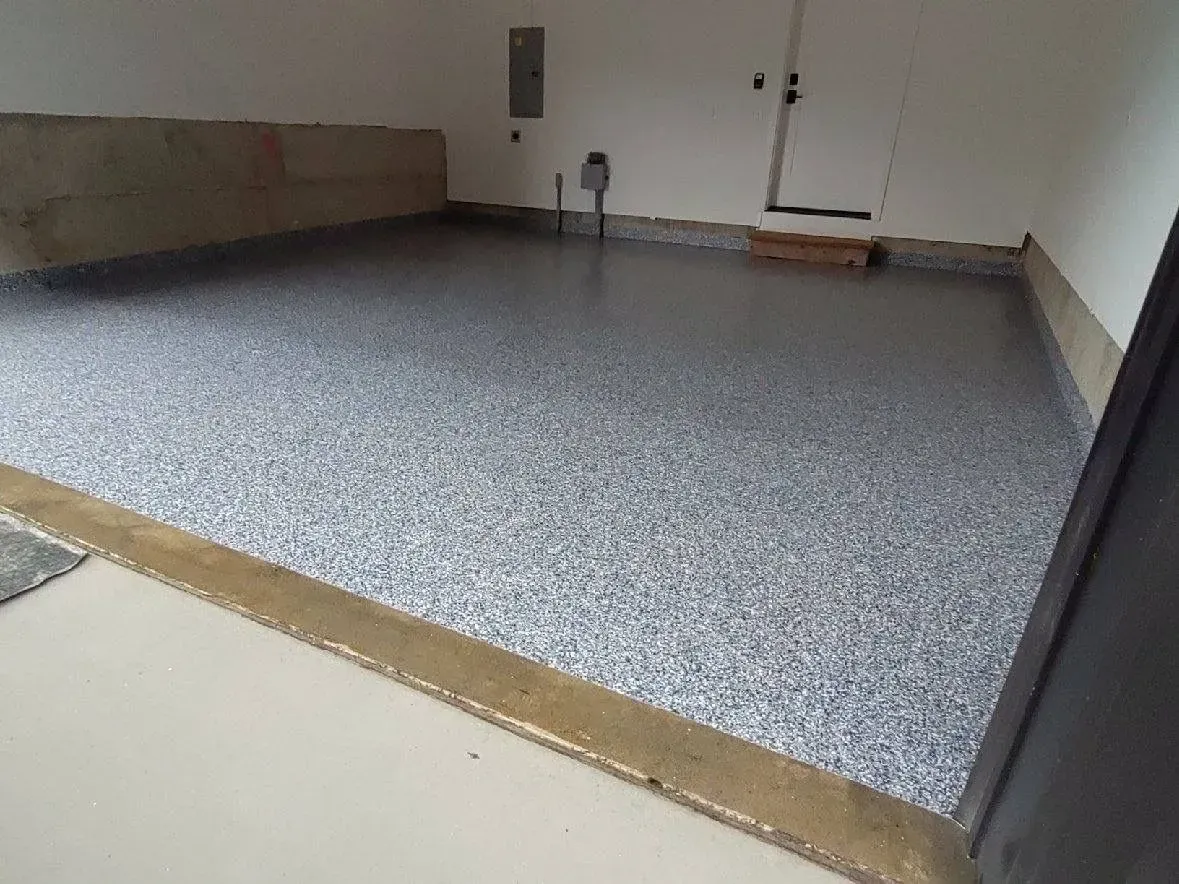 Garage with a speckled epoxy floor.
