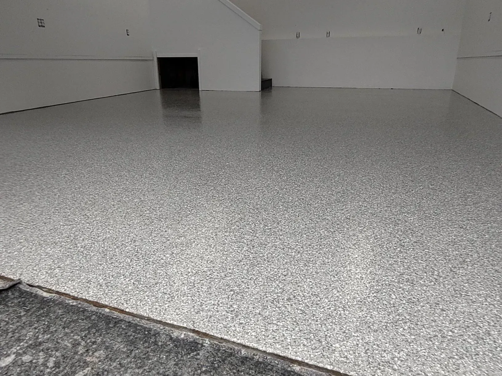 Gray speckled epoxy garage floor.