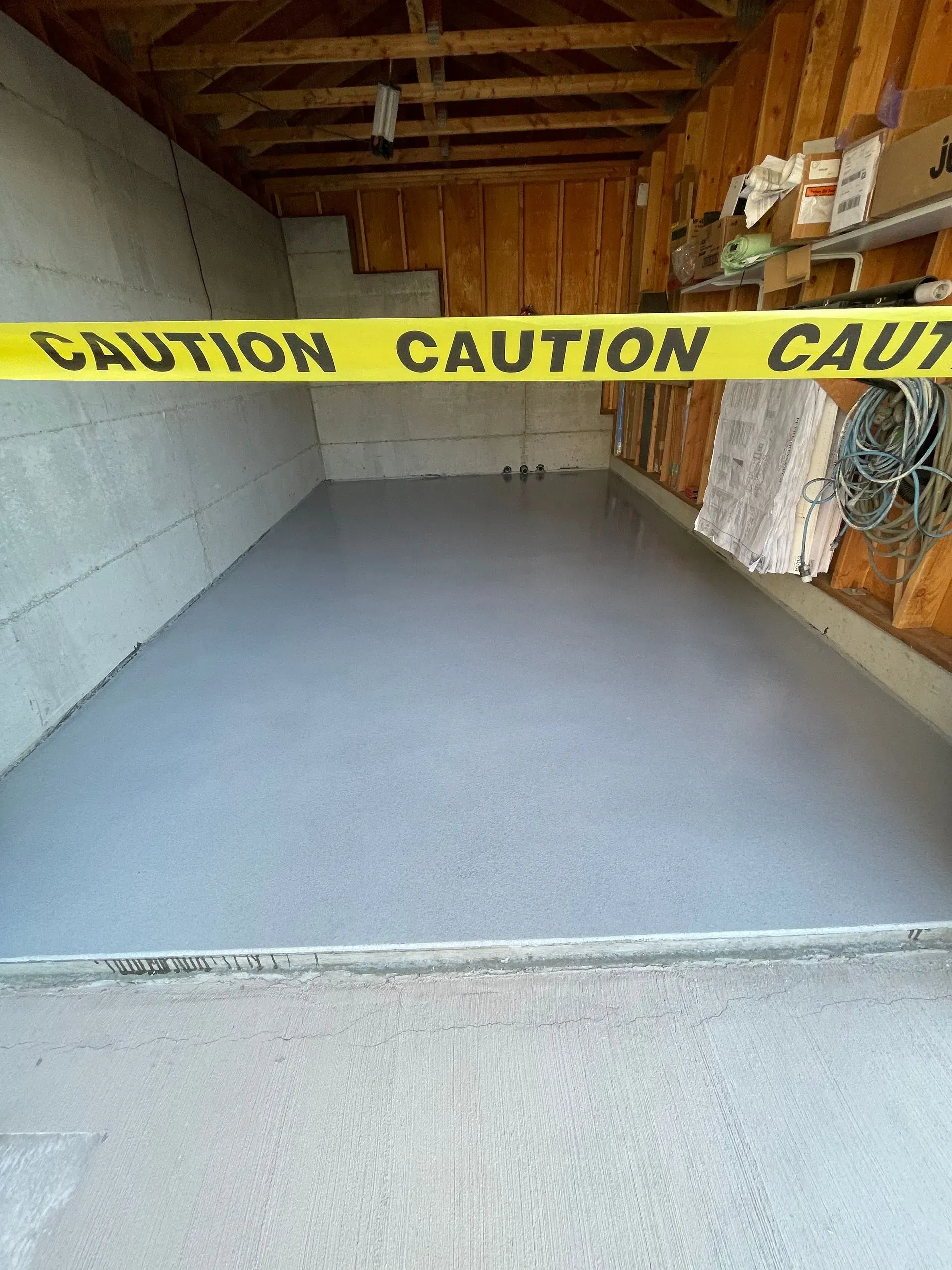Garage interior with new gray epoxy floor; yellow 