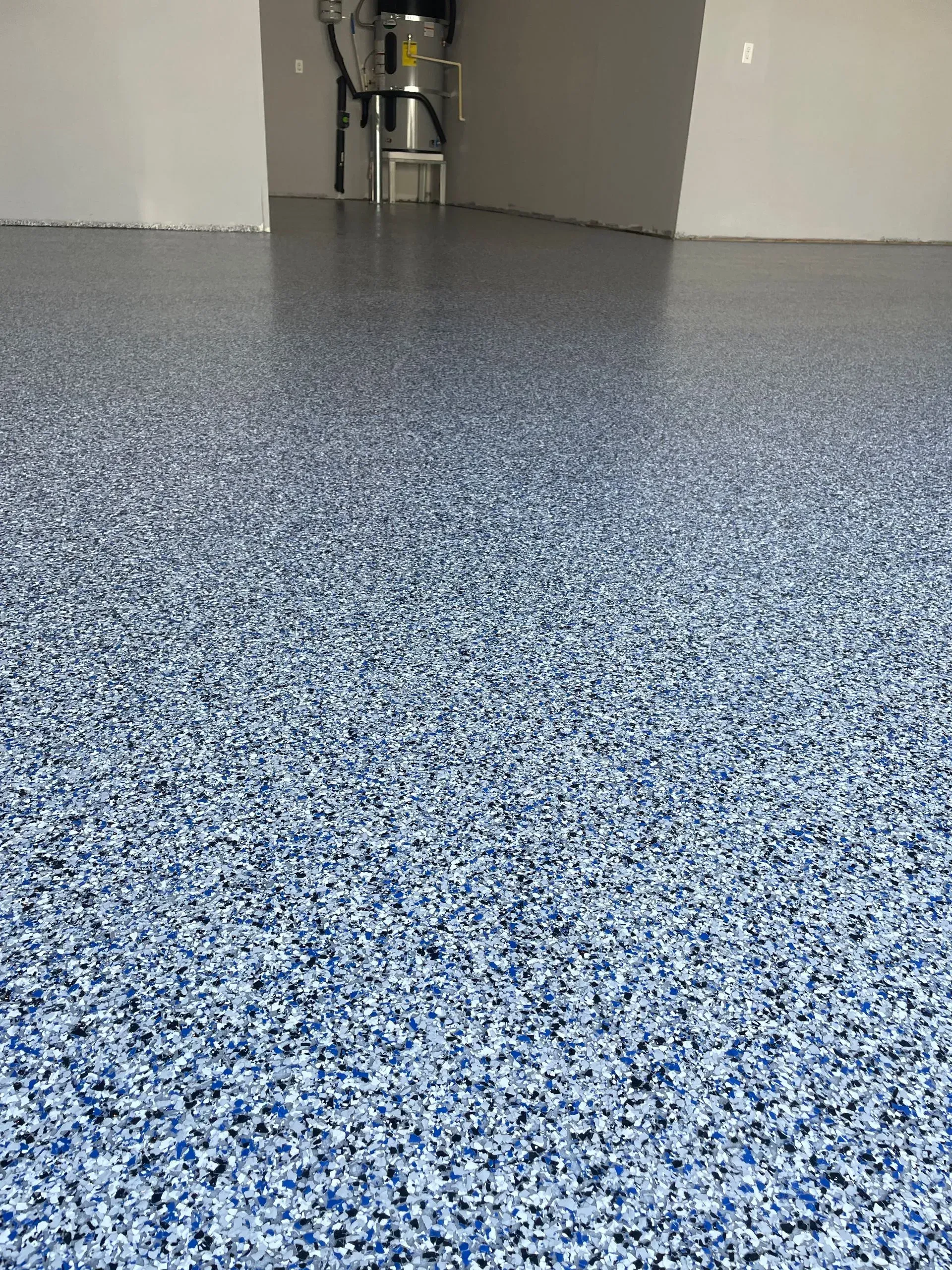 Blue and white speckled epoxy flooring in a room.