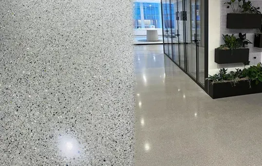 Two polished concrete floors: one exposed aggregate, one smooth and reflective, in a modern office setting.