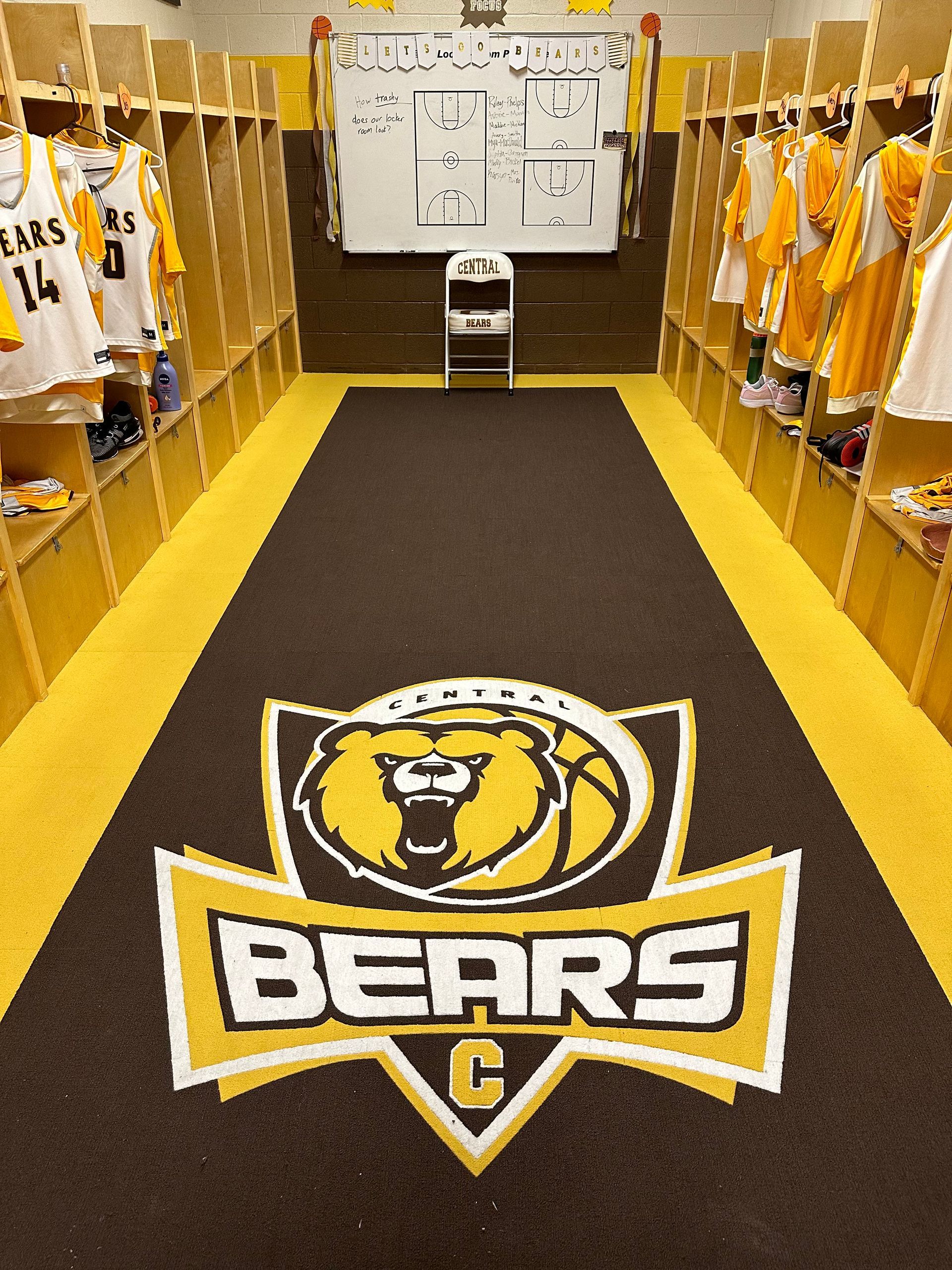 Locker room with brown, gold, and white color scheme. 