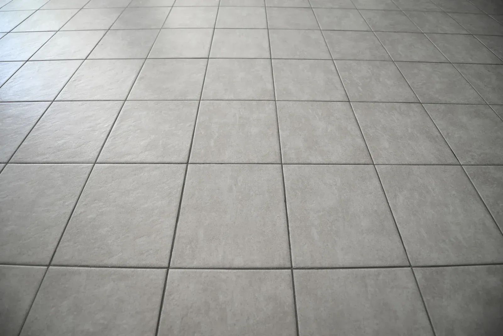 Gray tiled floor, viewed at a slight angle.
