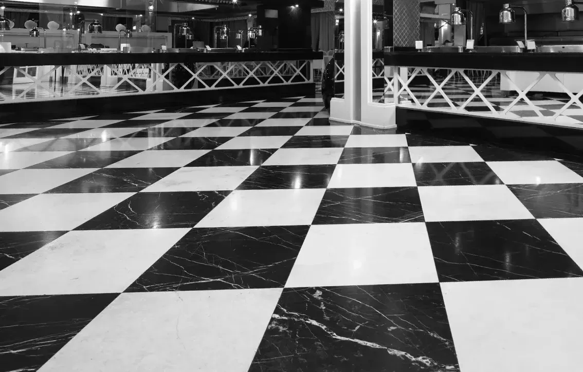 A black and white photo of a checkered floor