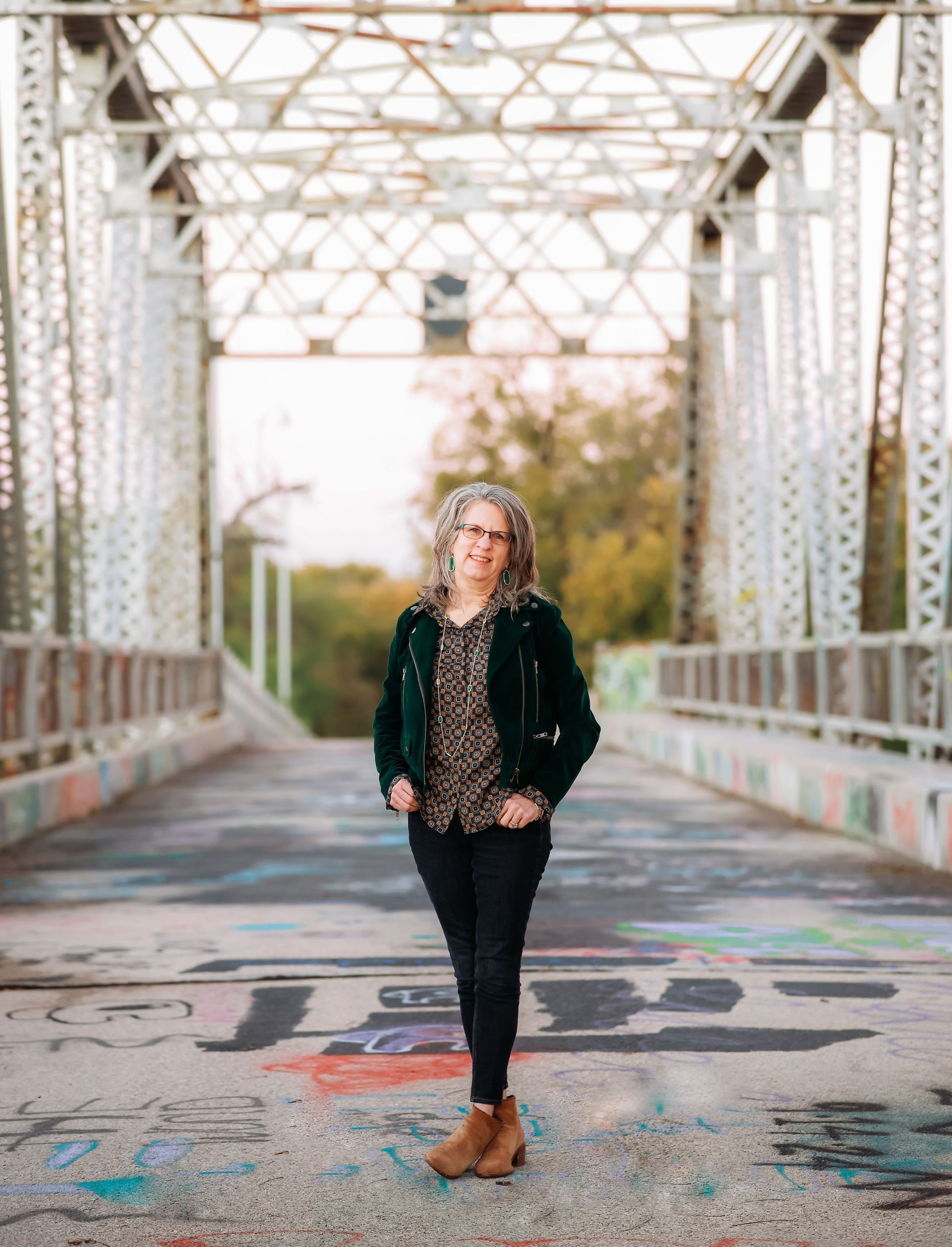 A man is laying on a couch talking to a woman.