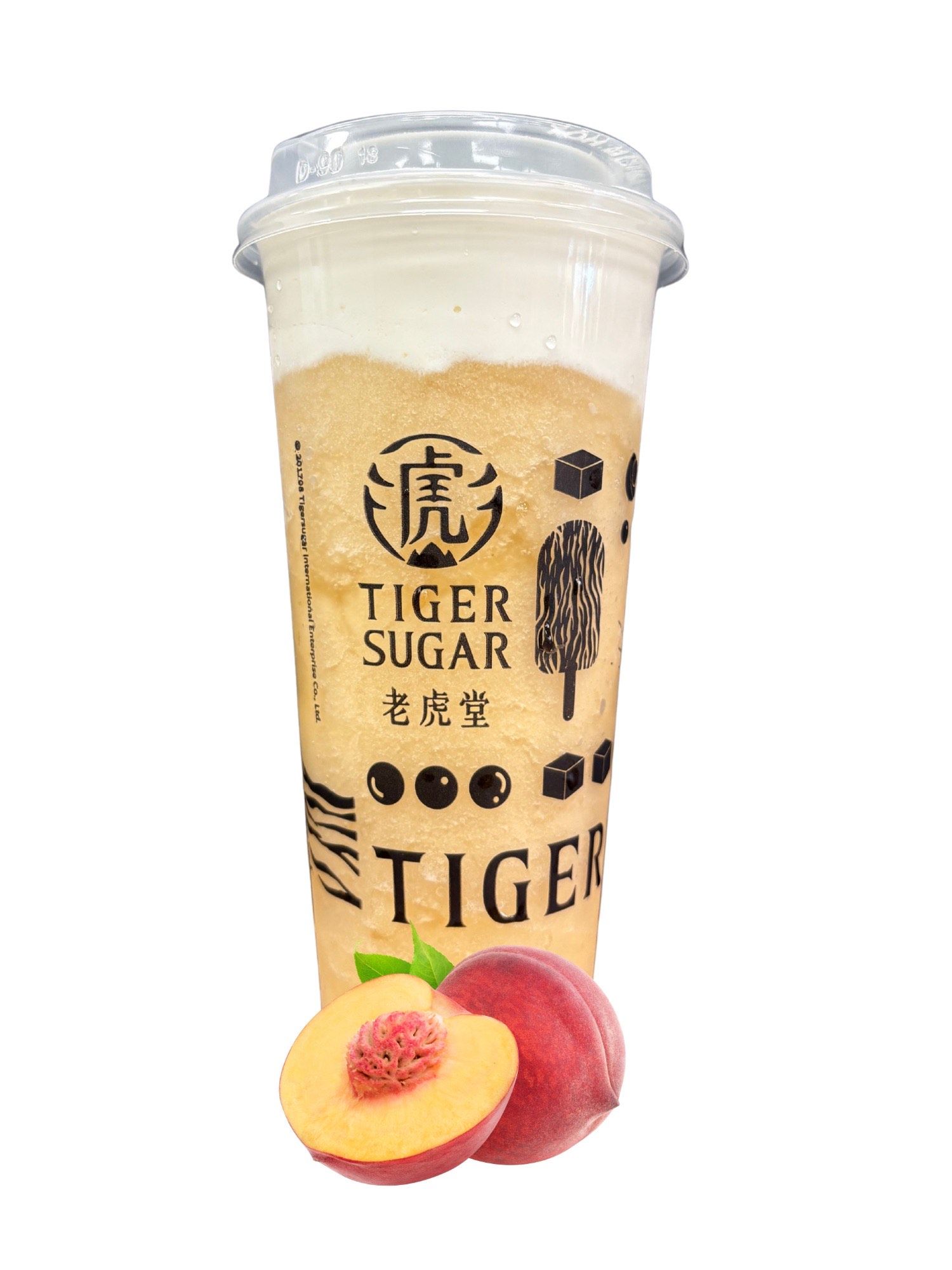 A tall Tiger Sugar drink with a creamy top, tapioca pearls, and a peach beside it.