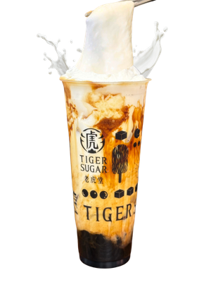 Tiger Sugar bubble tea with brown sugar stripes, white foam, and a milk splash.