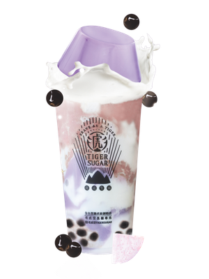 Tiger Sugar taro milk tea with boba, with a purple lid and milk splash, surrounded by boba pearls.