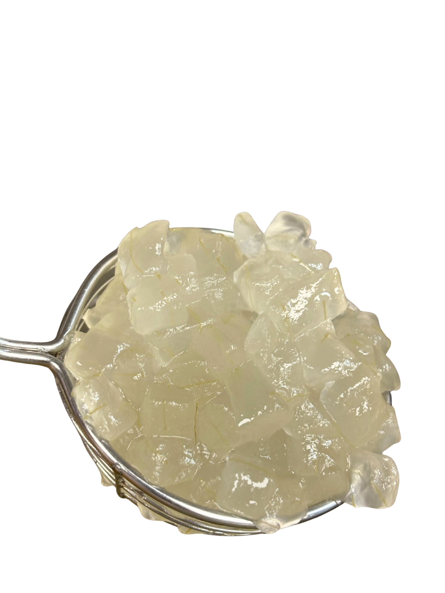 Cubes of translucent, gelatinous substance in a metal mesh strainer, held against a white background.