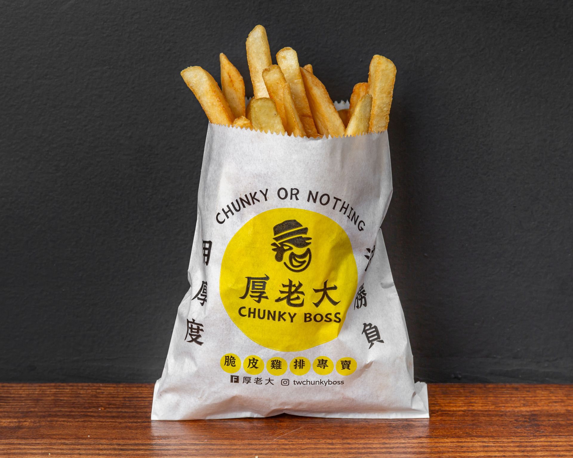 Bag of thick-cut French fries with a yellow circular logo that reads 