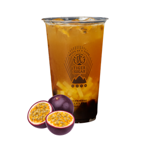 Passion fruit tea with passion fruits next to the cup. The cup contains yellow and brown liquid with ice and tapioca pearls. The cup has a logo.
