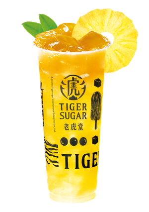 Pineapple Tiger Sugar drink in a tall clear cup, garnished with pineapple slices and leaves. Yellow and white design on cup.