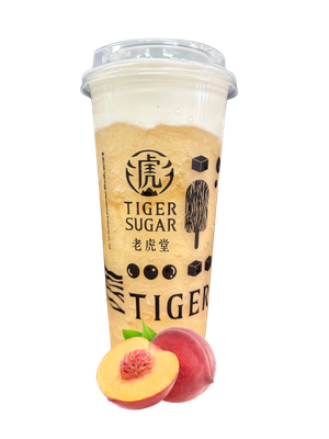 Tiger Sugar peach drink with a sliced peach; light orange drink with cream topping, clear cup.