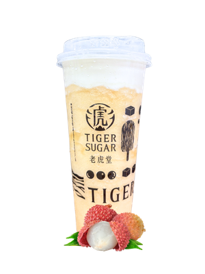 A Tiger Sugar lychee drink with a white foamy top, lychee fruits in the foreground. The cup has branding on it.