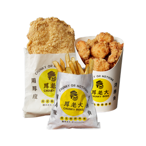 Fried chicken meal: large, crispy chicken breast, popcorn chicken, fries, in paper bags with yellow logo.