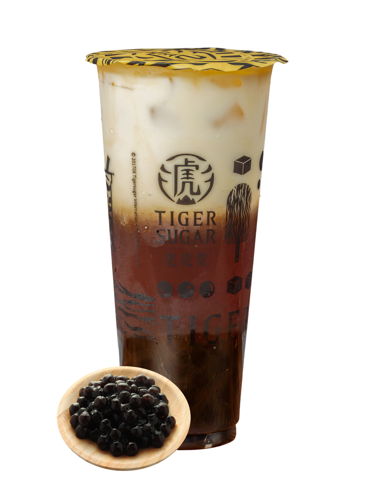 Tiger Sugar boba tea with layers of brown sugar syrup, milk, and tea, in a clear cup with black tapioca pearls on a wooden plate.