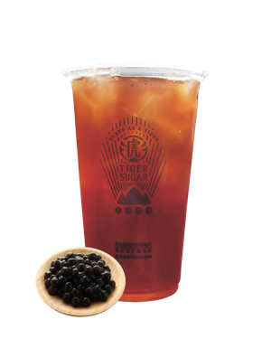 Iced Tiger Sugar milk tea with tapioca pearls in a wooden bowl. The clear cup has the brand's logo.