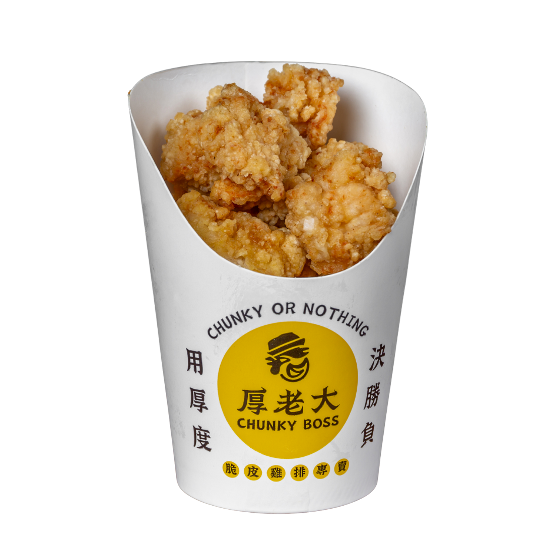 Fried chicken pieces in a white paper container labeled 