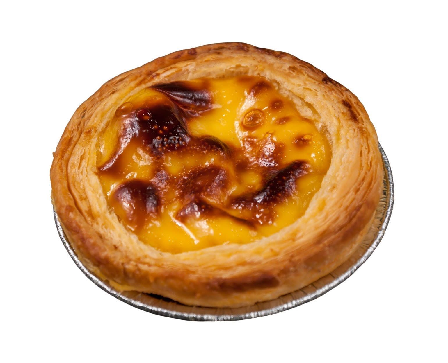 Cream puff cut in half, revealing a creamy custard filling. The golden pastry is resting on a plastic container.