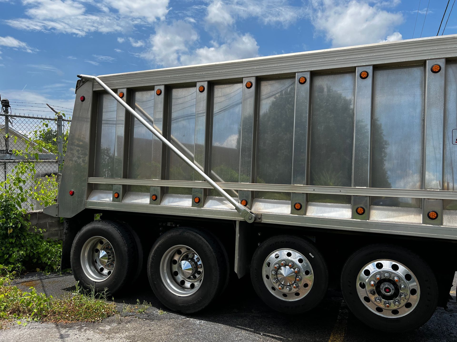 A dump truck is parked on the side of the road.