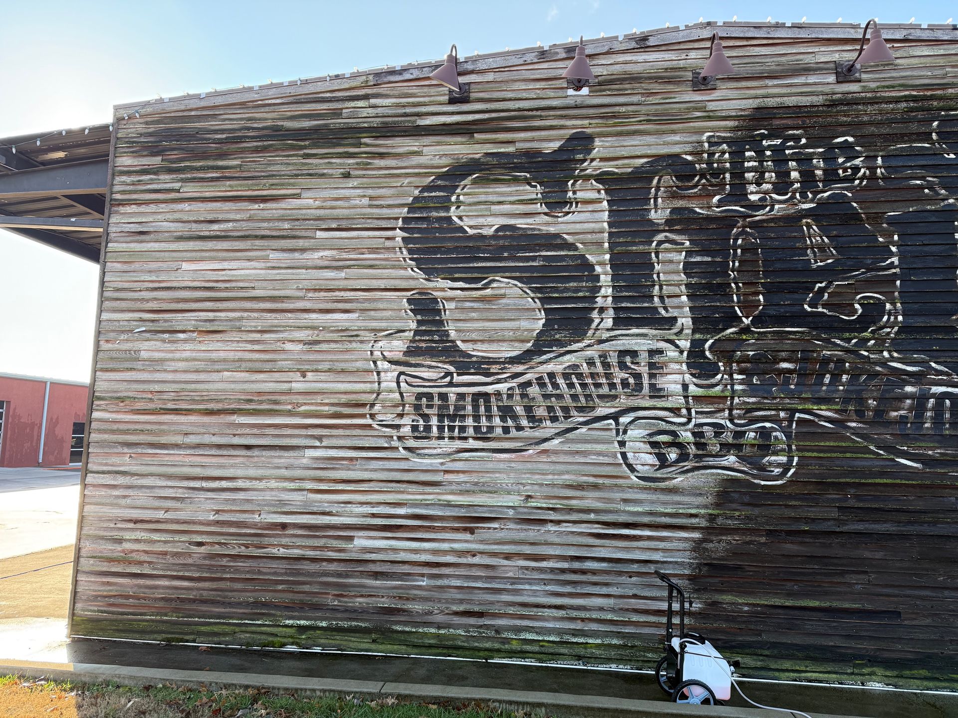 A wooden building with a sign that says smokehouse on it