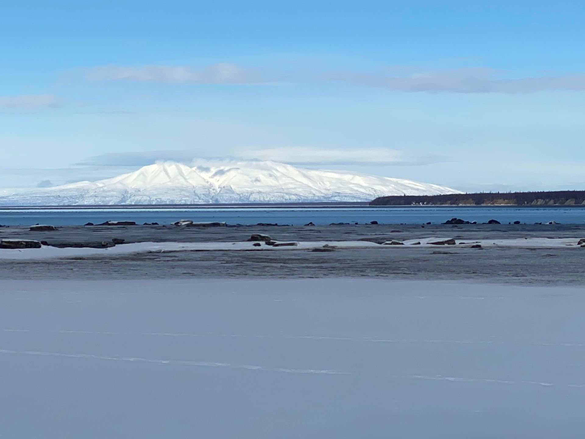 There is a mountain in the background and a lake in the foreground.