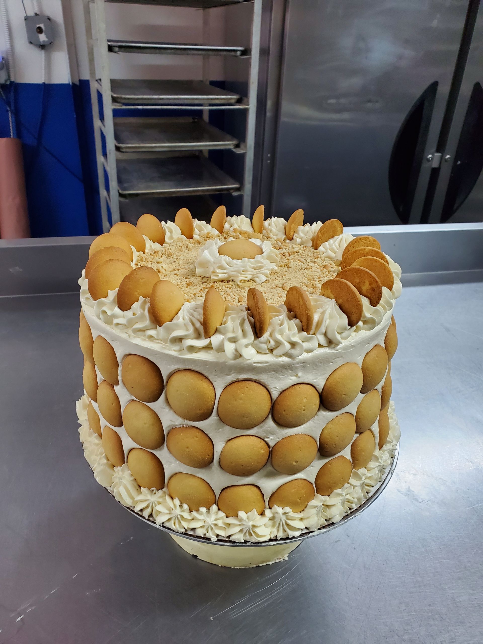 A cake with a lot of cookies on top of it