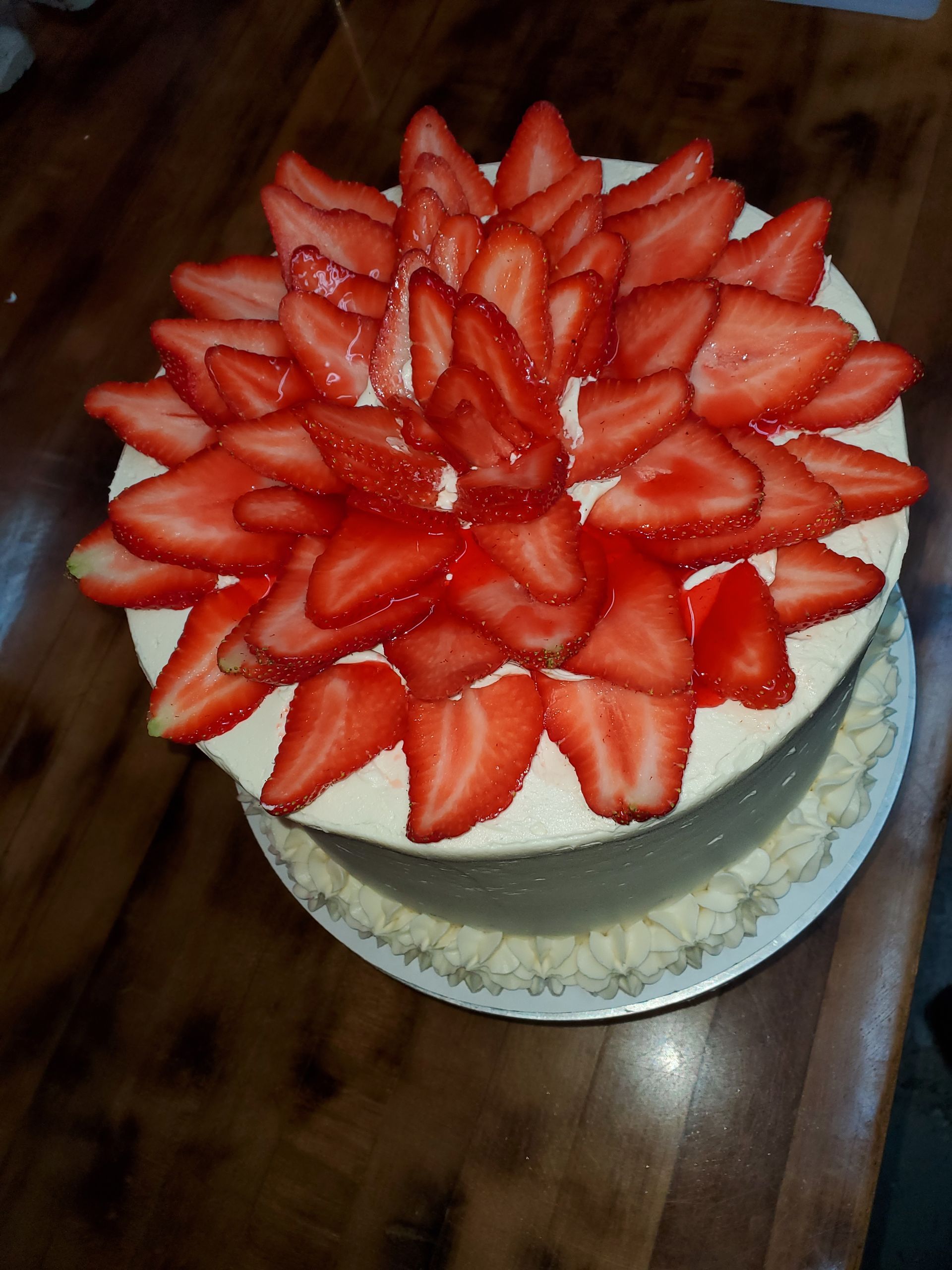 A cake with strawberries on top of it on a table