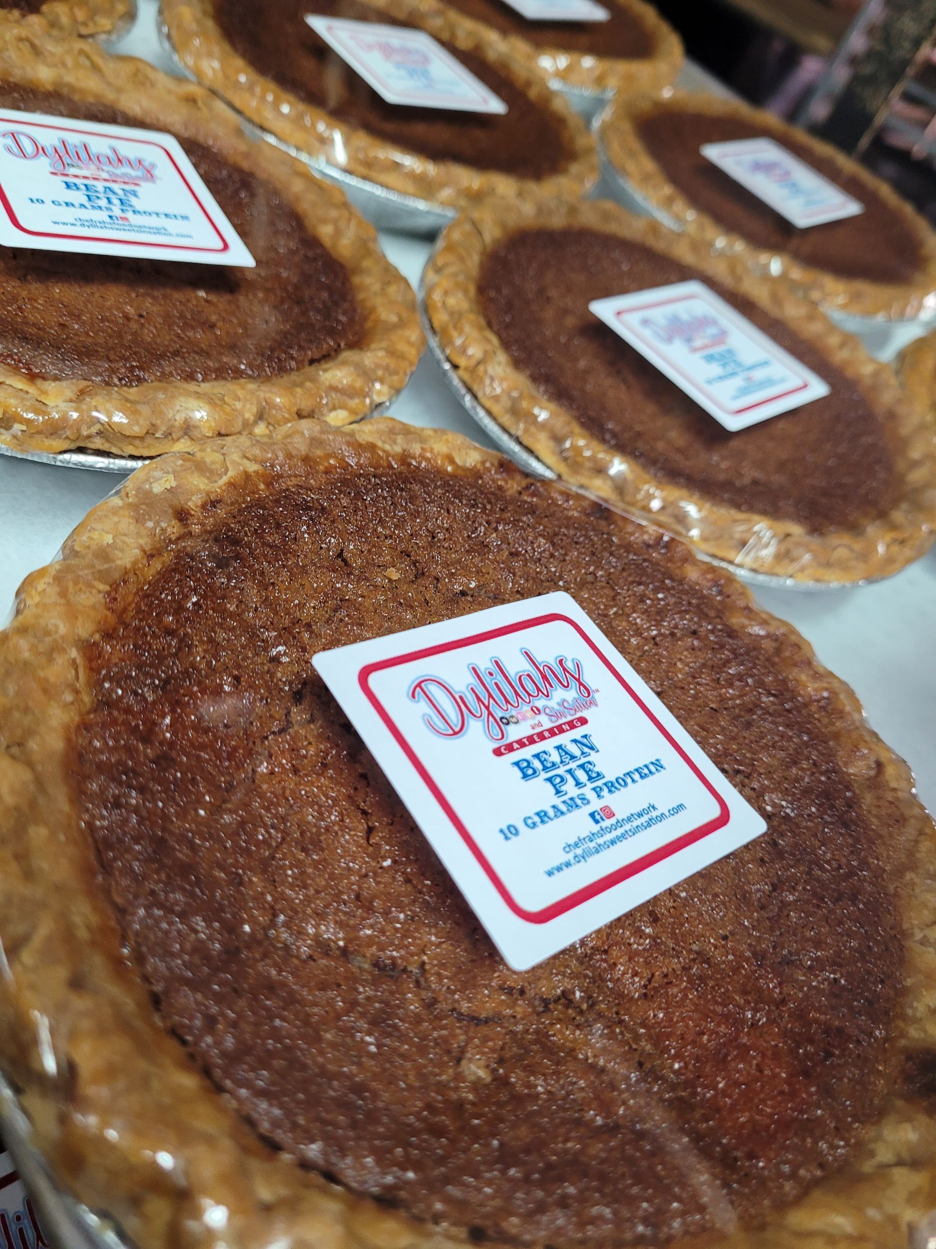 A bunch of pies are sitting on top of each other on a table.