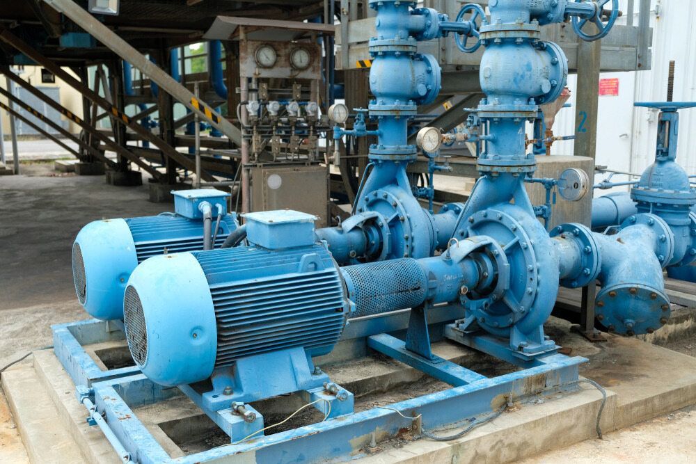 A Bunch of Blue Pumps Are Sitting on Top of Each Other in a Factory — Davidson's Electrical In Parkhurst, QLD