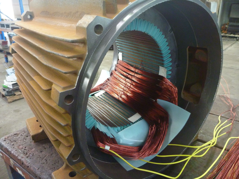 Cutaway of a large electric motor, showing copper windings and stator within the casing.— Davidson's Electrical In Mackay, QLD