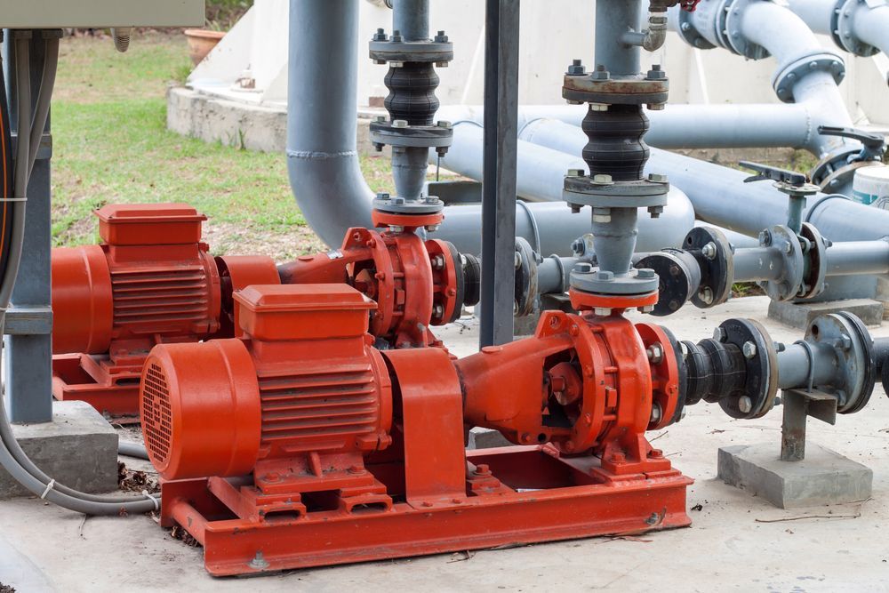 A Group of Pumps Are Sitting Next to Each Other in a Factory — Davidson's Electrical In Parkhurst, QLD