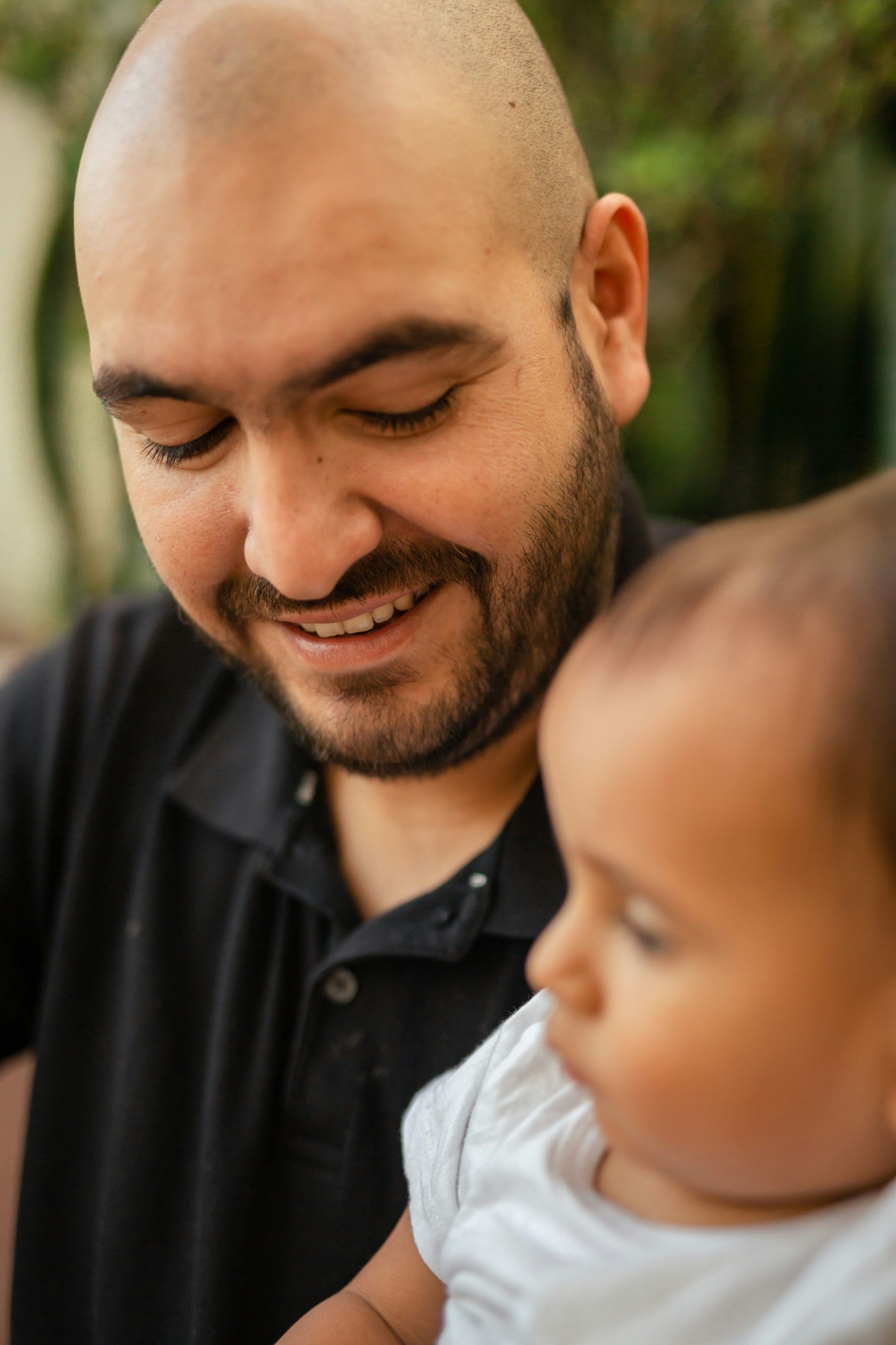 A wooden boat is floating on a lake with mountains in the background.