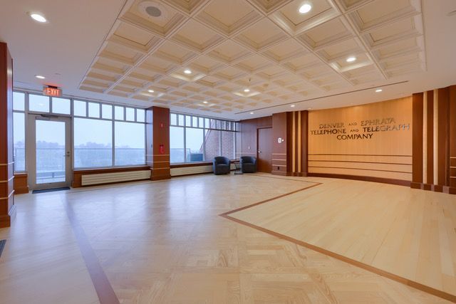 A large empty room with a wooden floor and ceiling.
