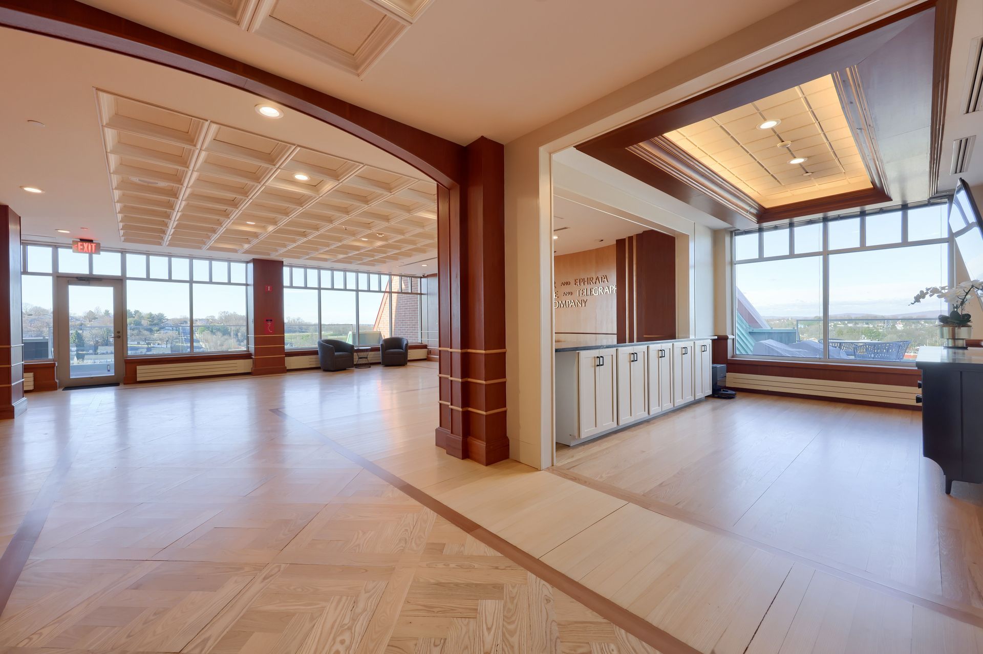 A large room with a lot of windows and wooden floors