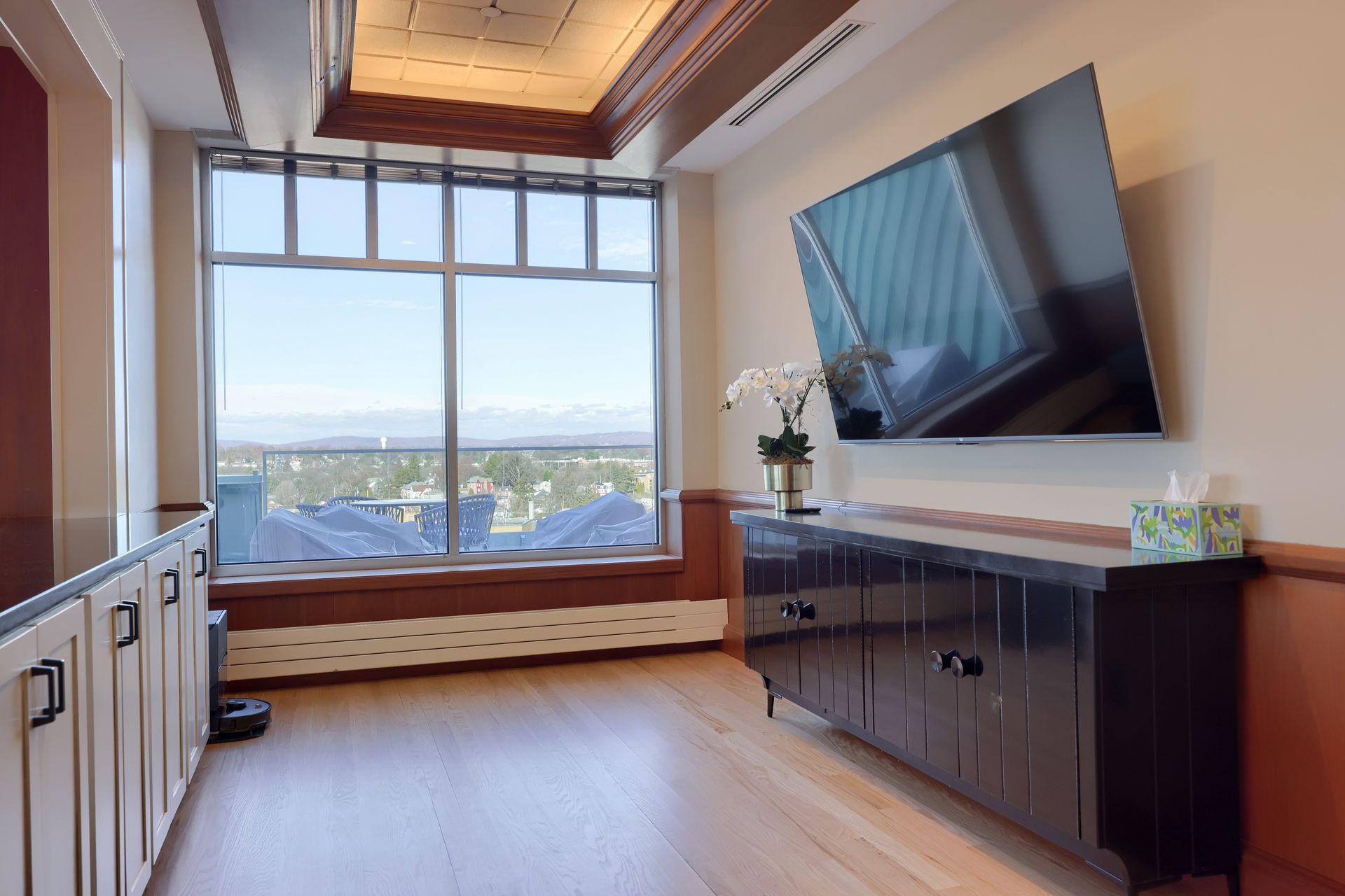 A living room with a large flat screen tv on the wall