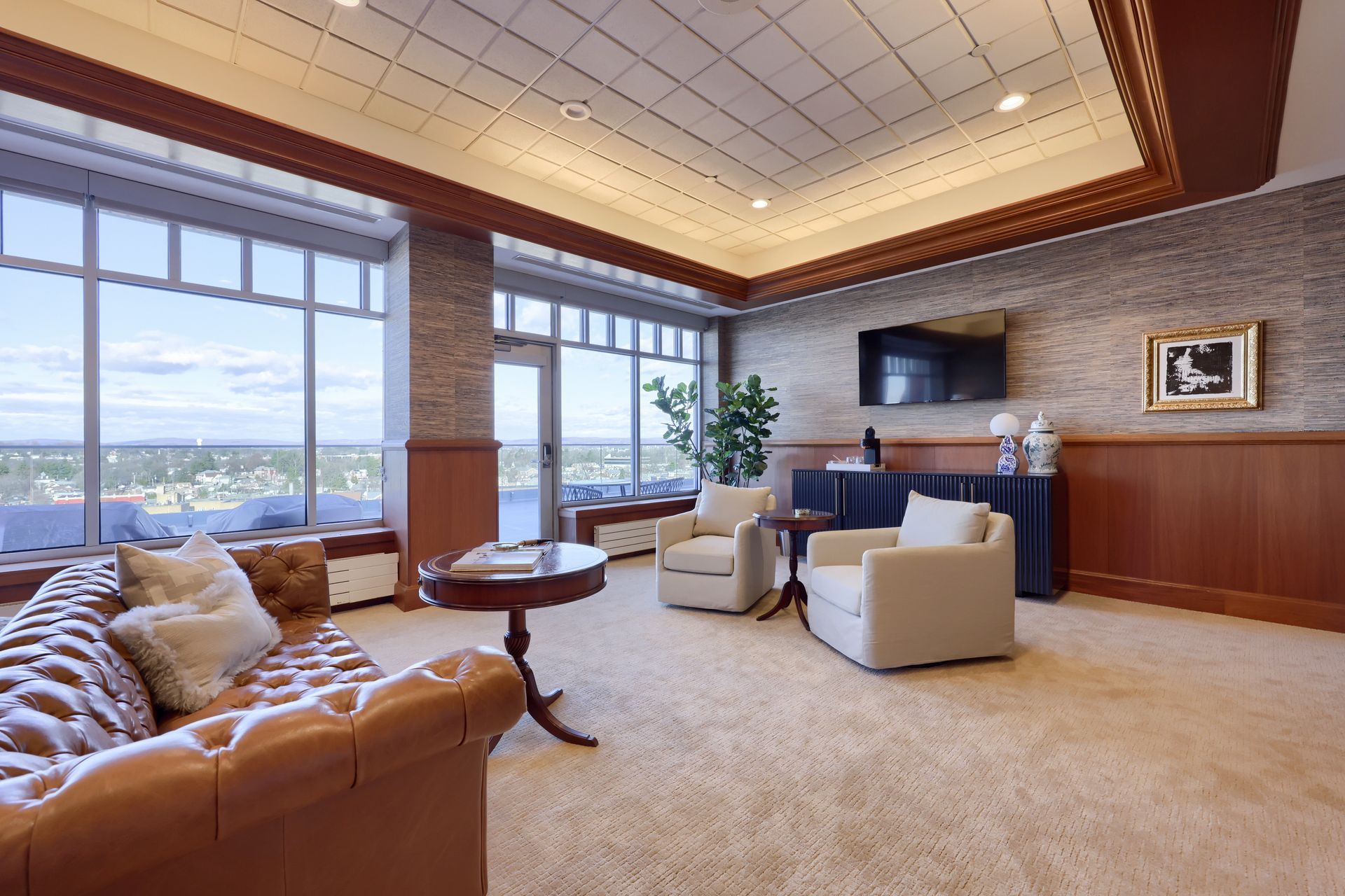A living room with a couch , chairs , table and television.