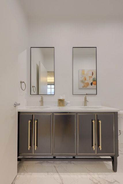 A bathroom with two sinks and two mirrors