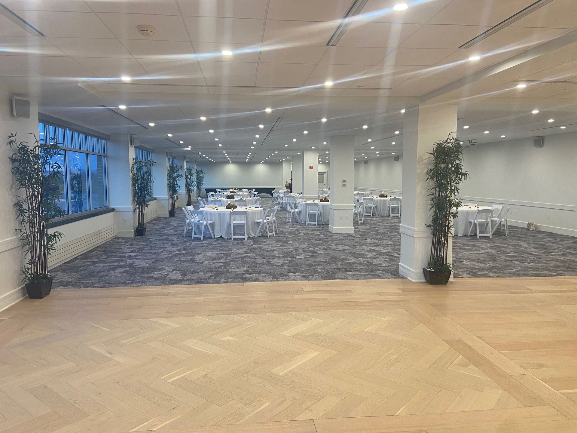 A large room with tables and chairs and a dance floor.