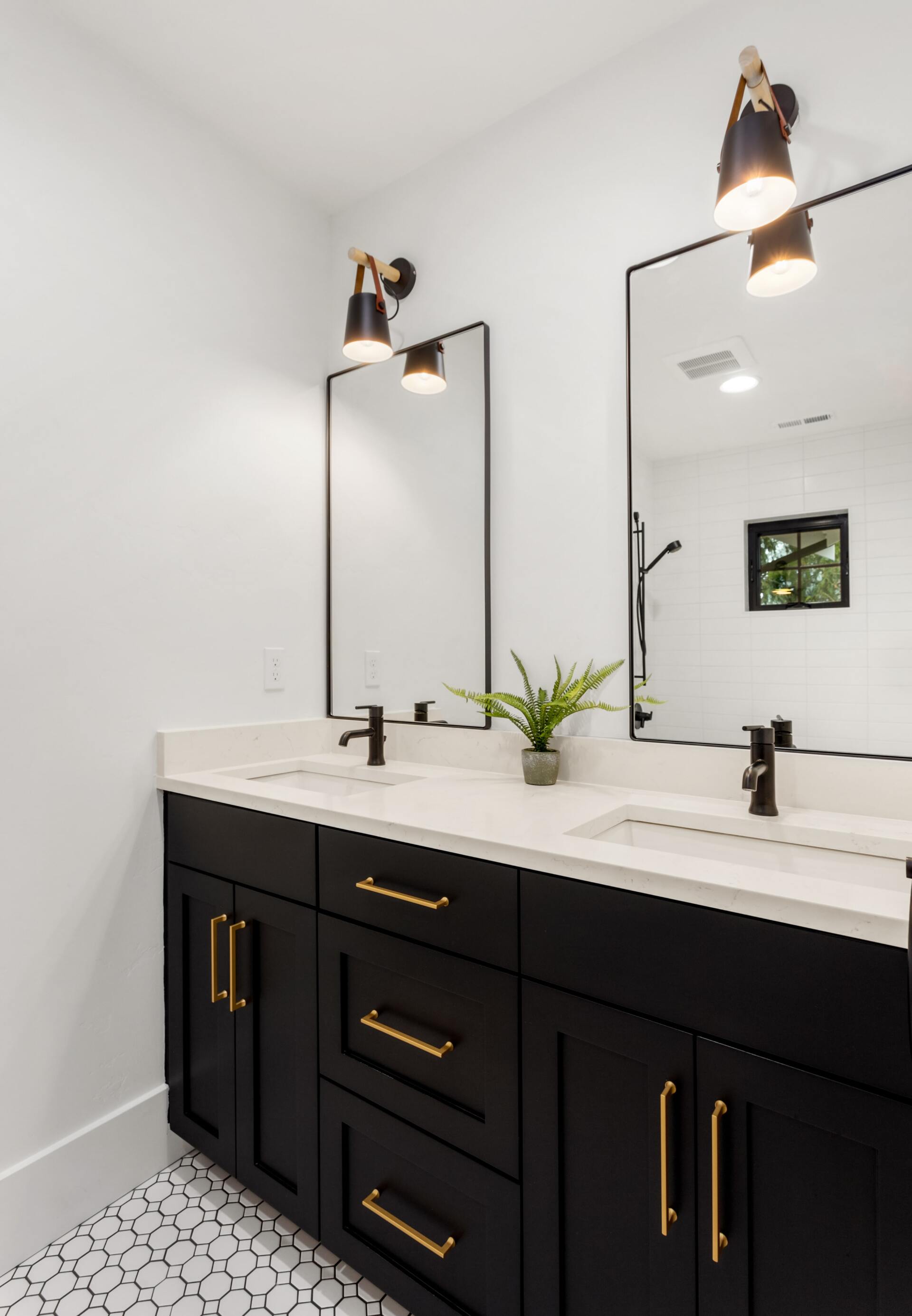 remodeled bathroom with dual sinks and dual mirrors