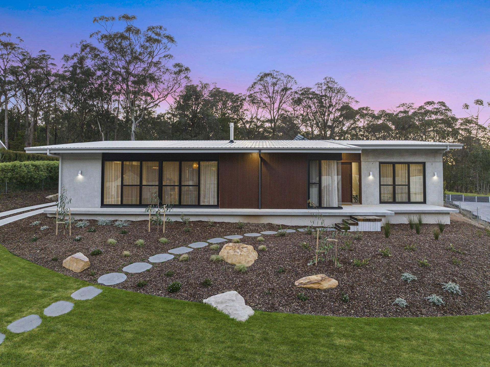 A modern house with many large windows.