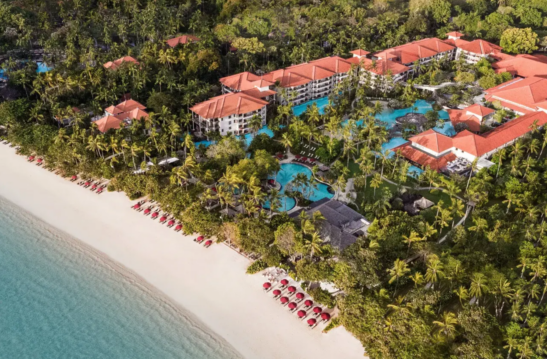 The Laguna offers spacious rooms, suites, and villas with stunning views of fragrant gardens or direct lagoon access. Each features Bali-inspired décor, including woven keben baskets and dulang tables with vibrant tropical fruits. Enjoy modern amenities like complimentary Wi-Fi and Smart TVs that sync with your devices, all set in a serene Nusa Dua beach location.