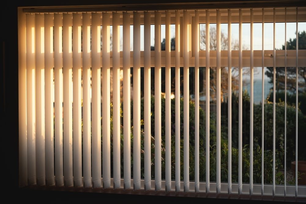 The Sun is Shining Through the Vertical Blinds of a Window — Lismore Blinds in North Lismore, NSW